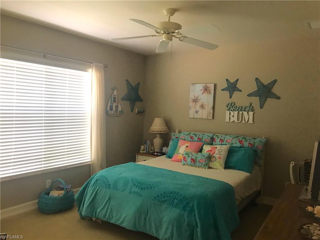 120 Forest Hills Boulevard Naples, FL 34113 - Photo 20 of 24 a bedroom with a bed and window
