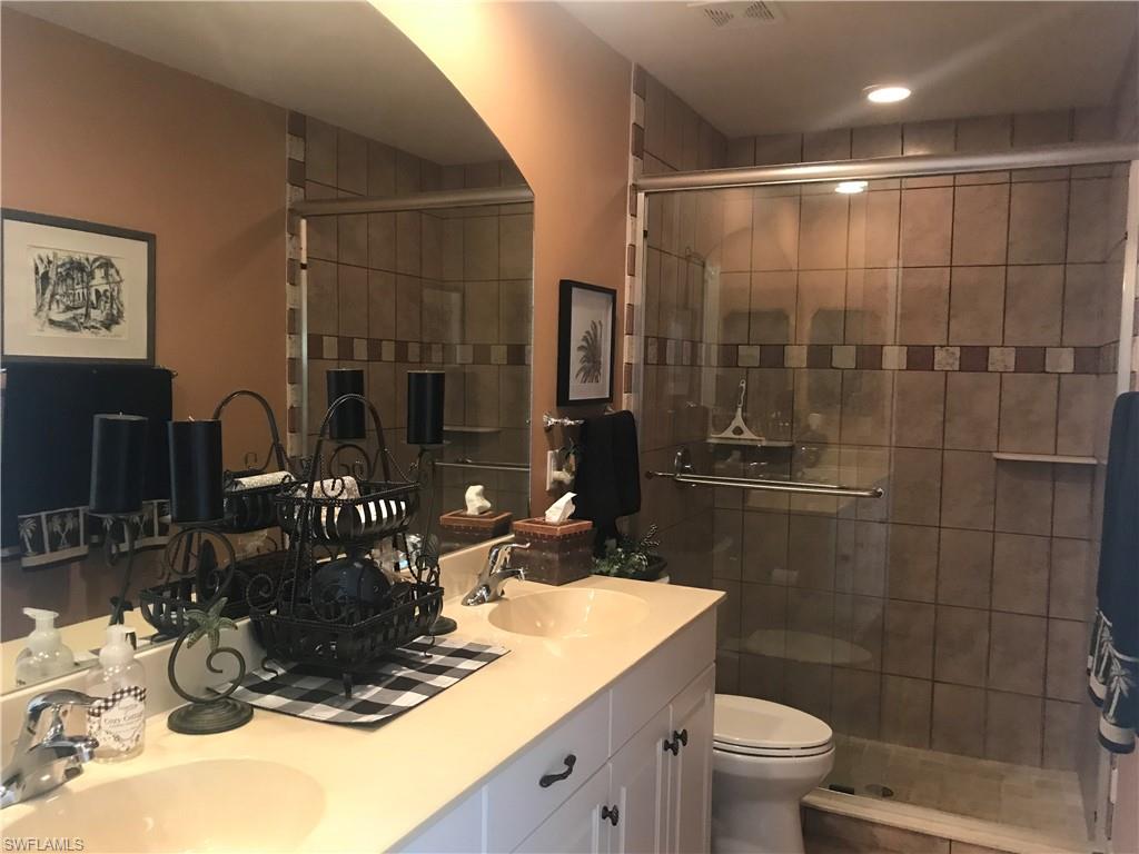 120 Forest Hills Boulevard Naples, FL 34113 - Photo 21 of 24 a bathroom with a sink a toilet and shower