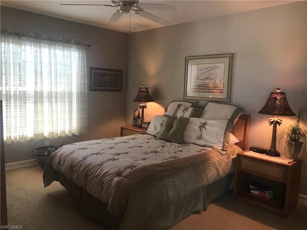 120 Forest Hills Boulevard Naples, FL 34113 - Photo 22 of 24 a bedroom with a bed and wooden floor