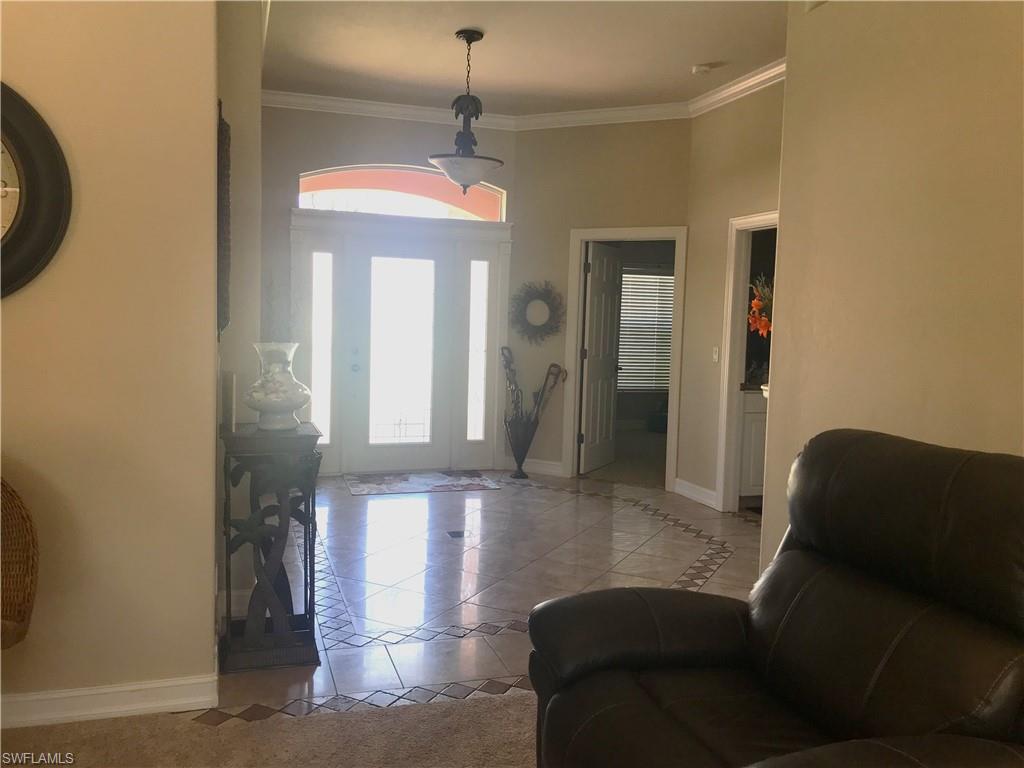 120 Forest Hills Boulevard Naples, FL 34113 - Photo 24 of 24 a living room with furniture and a chandelier