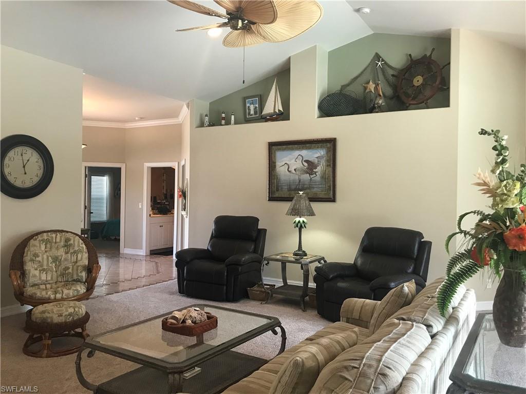 120 Forest Hills Boulevard Naples, FL 34113 - Photo 3 of 24 a living room with furniture and a mirror