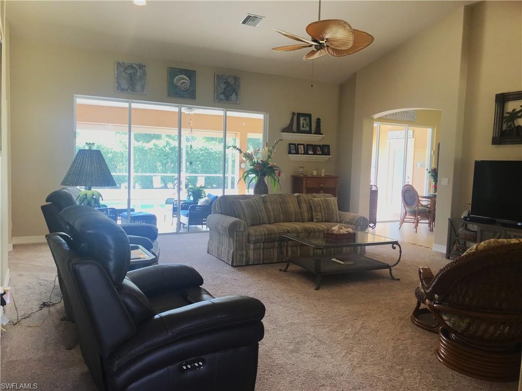120 Forest Hills Boulevard Naples, FL 34113 - Photo 4 of 24 a living room with furniture and a flat screen tv