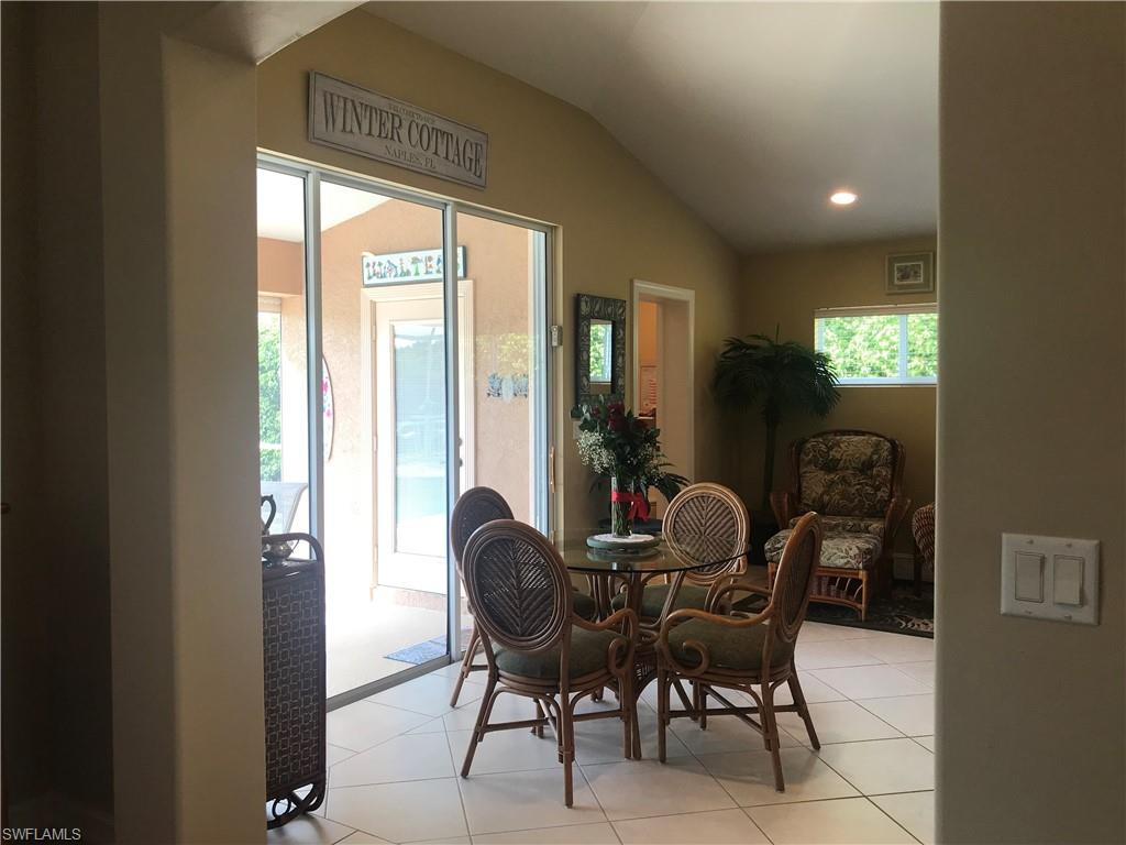 120 Forest Hills Boulevard Naples, FL 34113 - Photo 9 of 24 a dining room with furniture and windows
