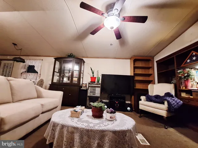 a work room with furniture and a flat screen tv