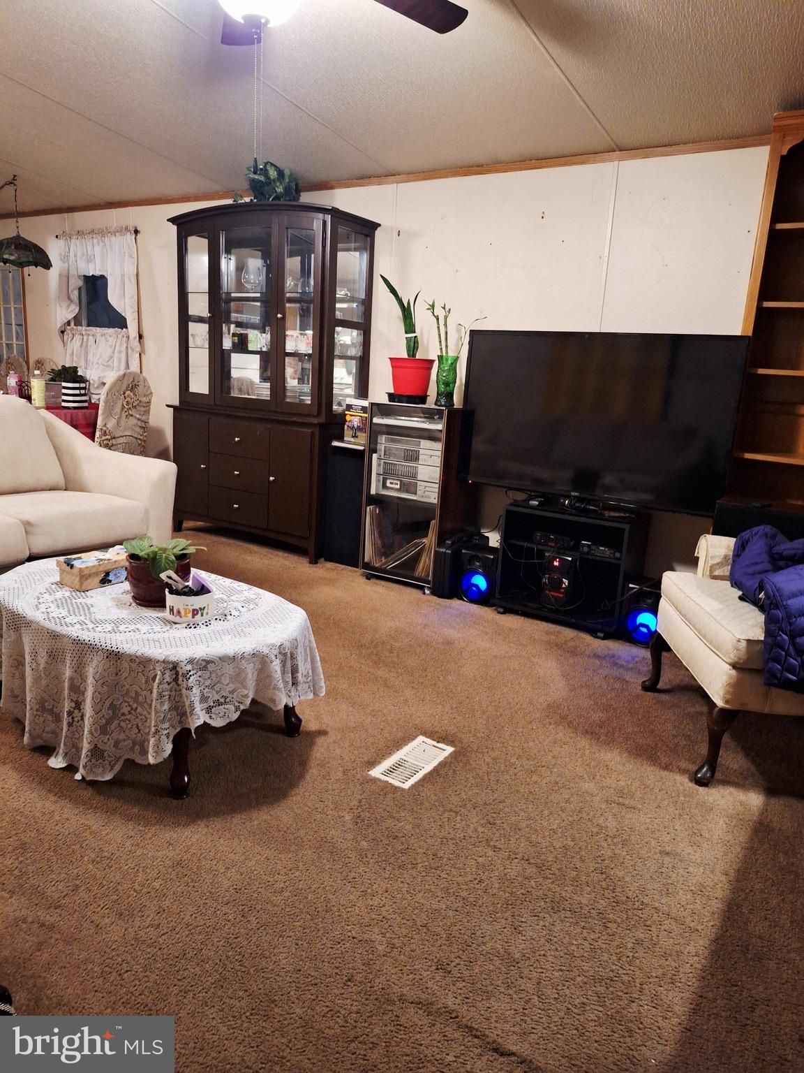 545 Imperial Way Falling Waters, WV 25419 - Photo 16 of 20 a living room with furniture and a flat screen tv