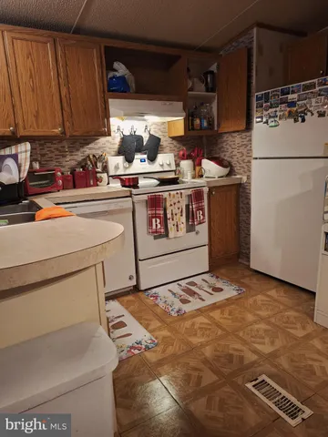 a kitchen with a refrigerator and a stove