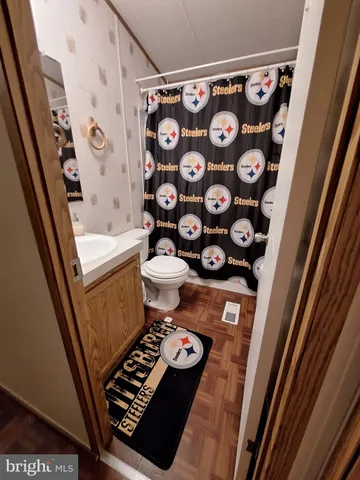 a bathroom with a toilet and a shower curtain