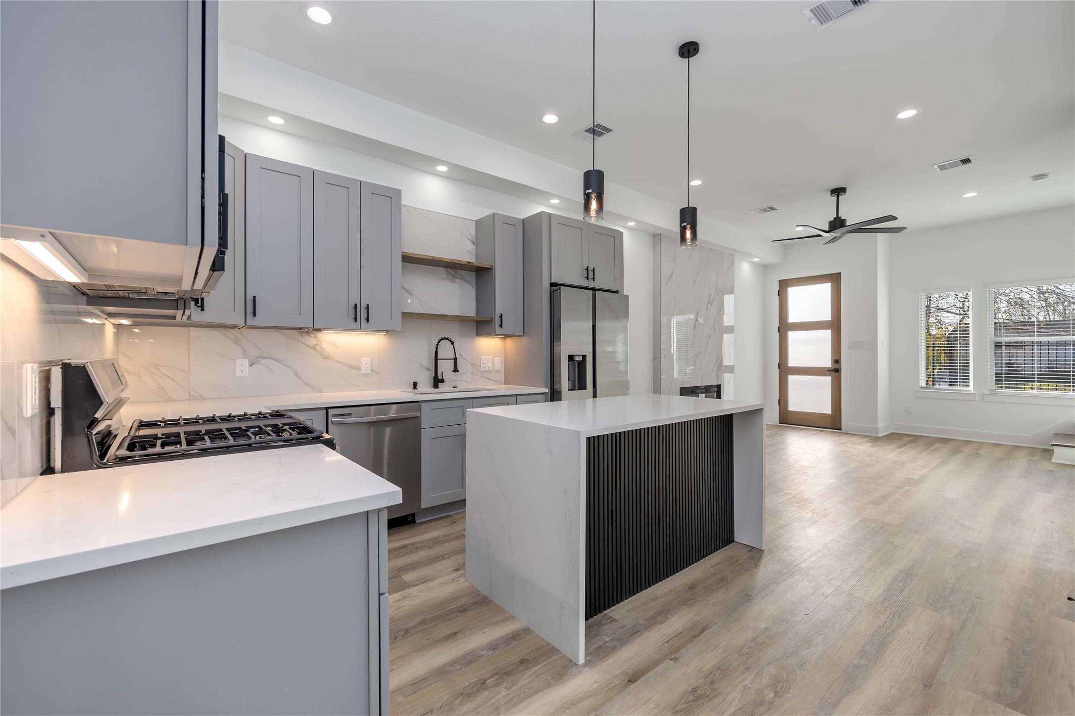 4533 Larkspur Street, Unit B Houston, TX 77051 - Photo 11 of 36 a kitchen with a refrigerator a sink and wooden floor