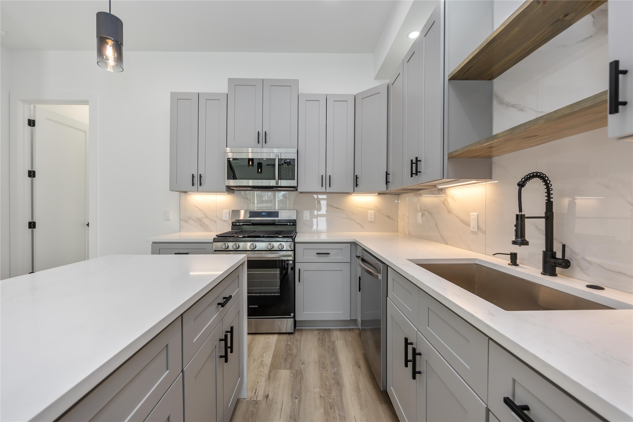 4533 Larkspur Street, Unit B Houston, TX 77051 - Photo 13 of 36 a kitchen with a sink stove and cabinets