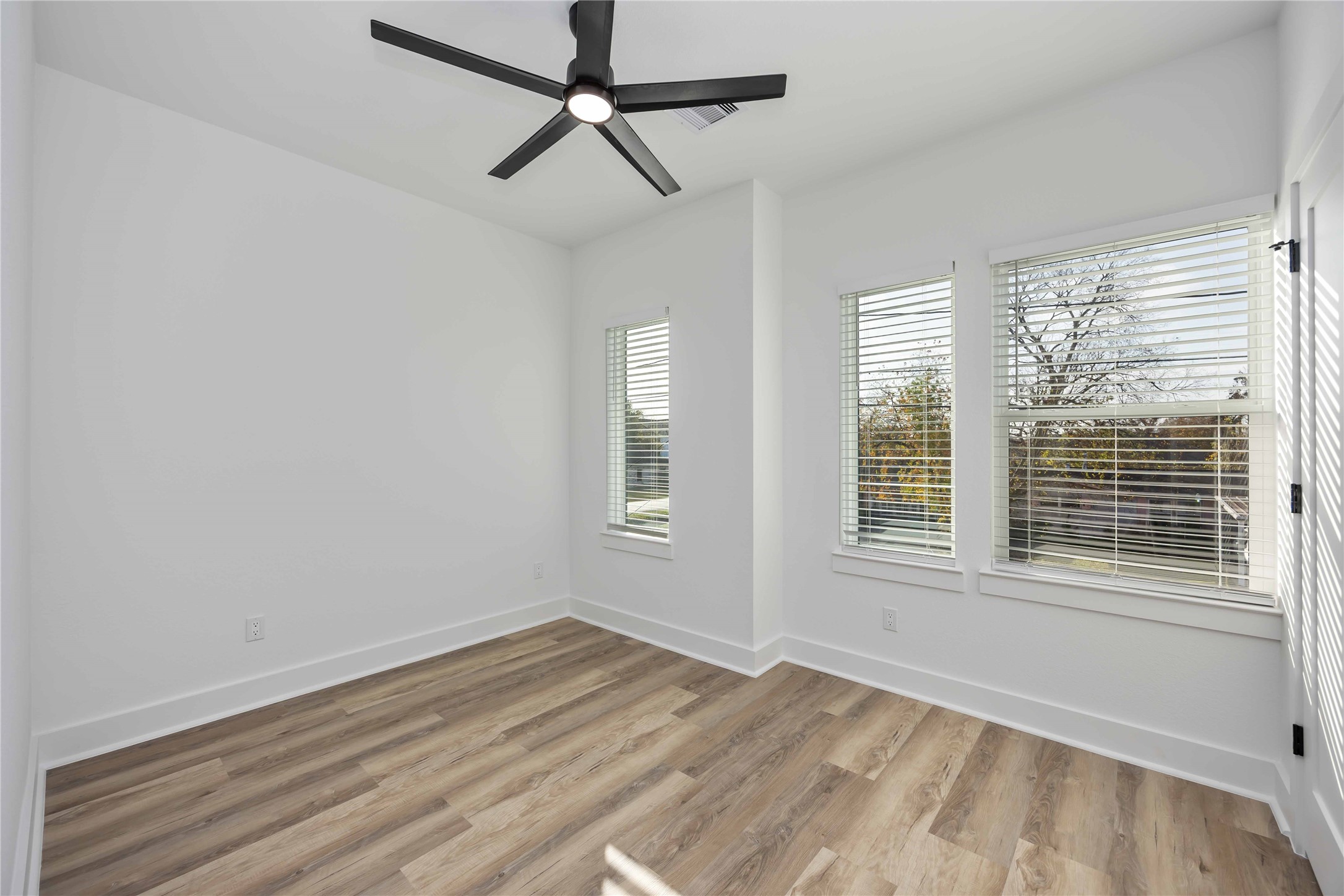 4533 Larkspur Street, Unit B Houston, TX 77051 - Photo 29 of 36 a view of empty room with wooden floor and fan