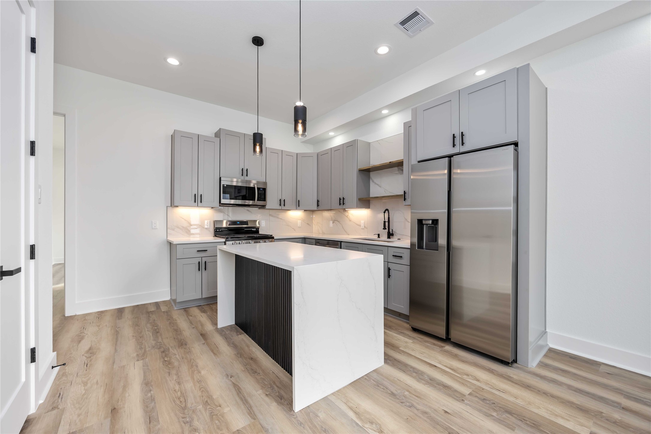 4533 Larkspur Street, Unit B Houston, TX 77051 - Photo 6 of 36 a kitchen with stainless steel appliances granite countertop a refrigerator a sink a stove and a refrigerator