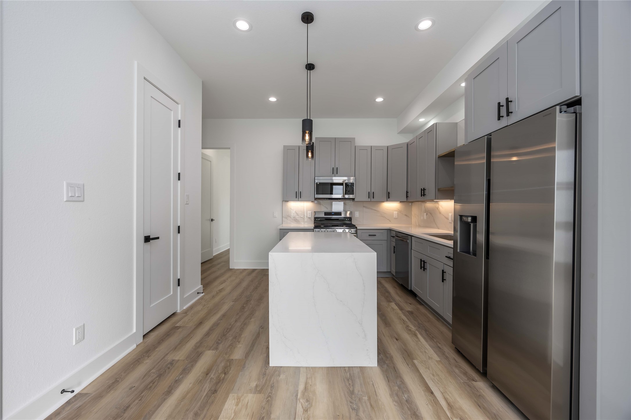 4533 Larkspur Street, Unit B Houston, TX 77051 - Photo 10 of 36 a kitchen with stainless steel appliances granite countertop a refrigerator a sink and a stove