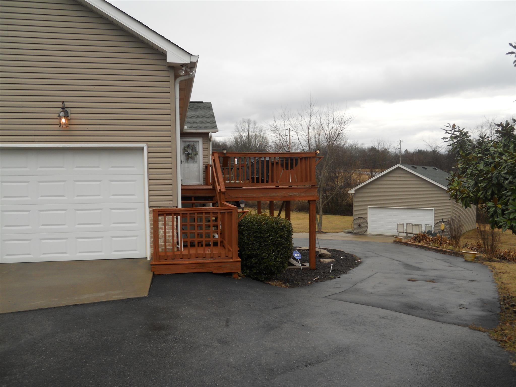 7017 Beckwith Road Mount Juliet, TN 37122 - Photo 3 of 28 Side of home showing the one car attached garage and the double car detached garage