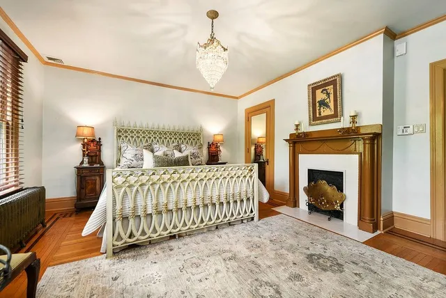 a bedroom with a bed and a fireplace