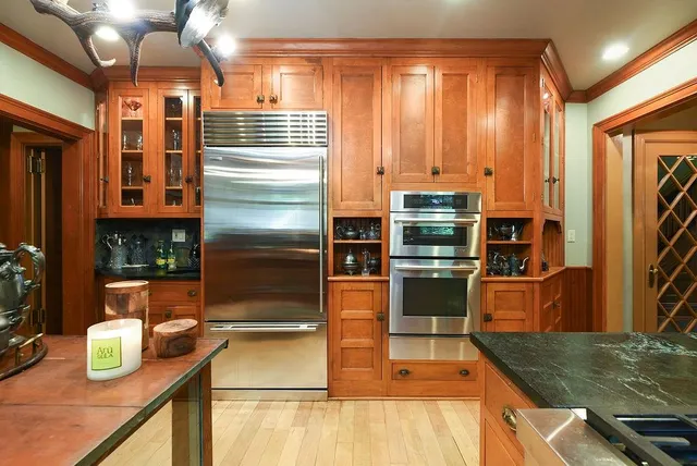 a kitchen with stainless steel appliances granite countertop a refrigerator and a stove