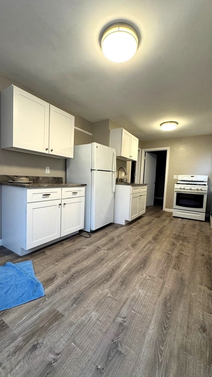 220 Hamilton Street, Unit TWNHS Cambridge, MA 02139 - Photo 2 of 11 a view of a kitchen with a sink dishwasher and a microwave