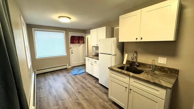 a kitchen with a stove a sink and a refrigerator