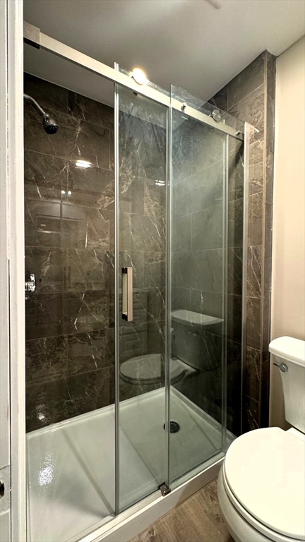 220 Hamilton Street, Unit TWNHS Cambridge, MA 02139 - Photo 4 of 11 a bathroom with a shower and toilet