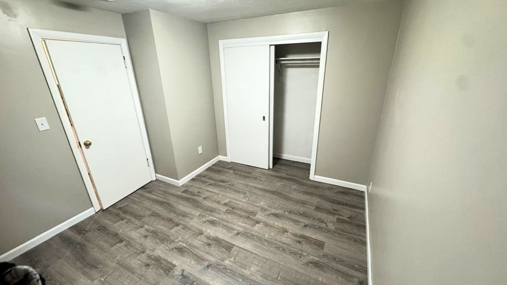 220 Hamilton Street, Unit TWNHS Cambridge, MA 02139 - Photo 8 of 11 an empty room with wooden door