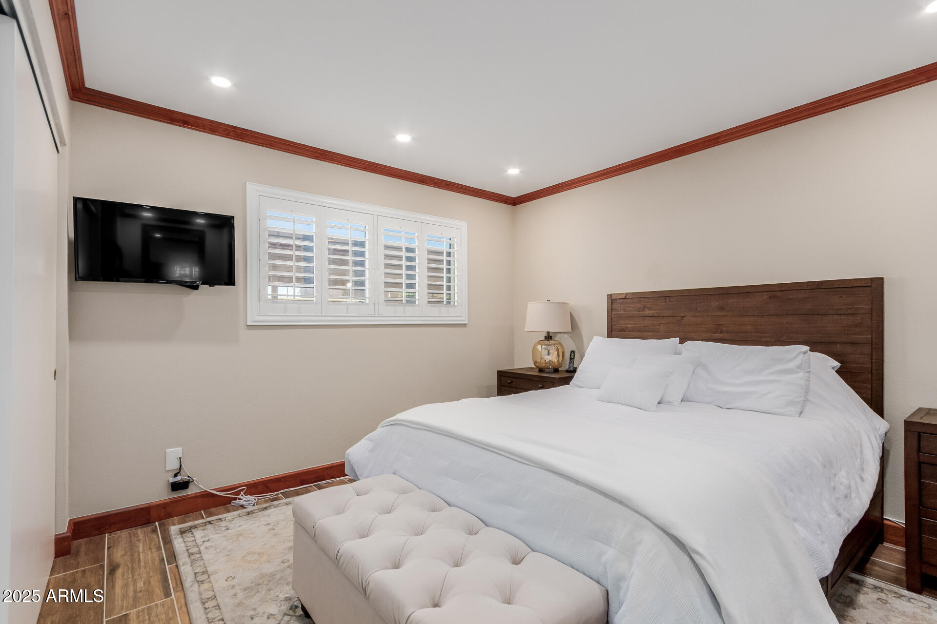 5525 East Thomas Road, Unit E3 Phoenix, AZ 85018 - Photo 15 of 34 a bedroom with a bed and a flat screen tv