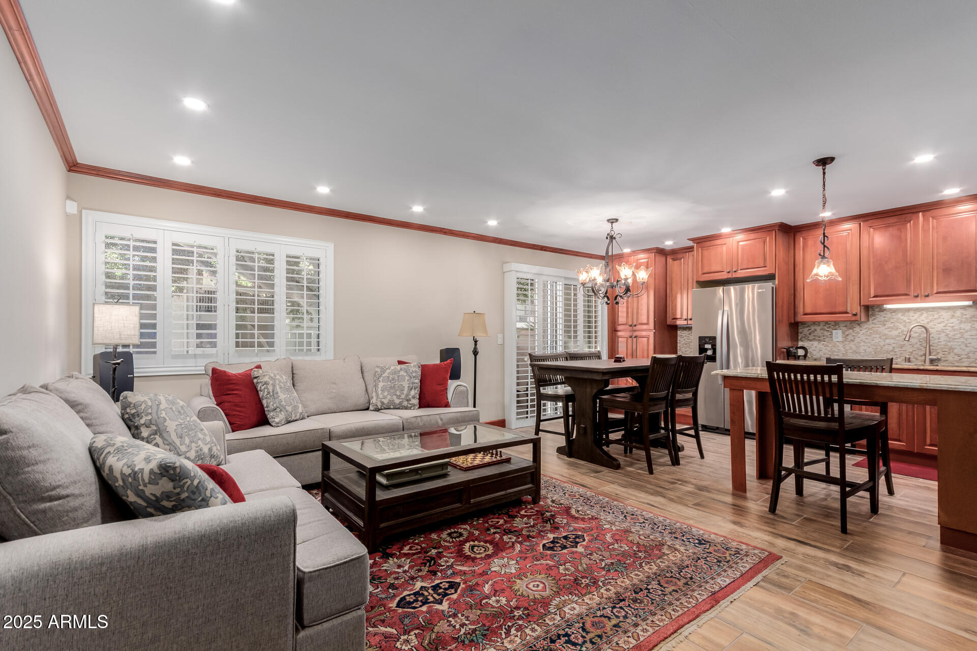 5525 East Thomas Road, Unit E3 Phoenix, AZ 85018 - Photo 6 of 34 a living room with furniture and a dining table with wooden floor