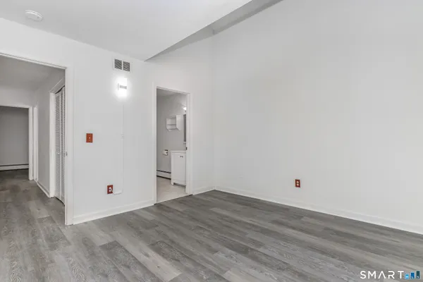 a view of a room with wooden floor