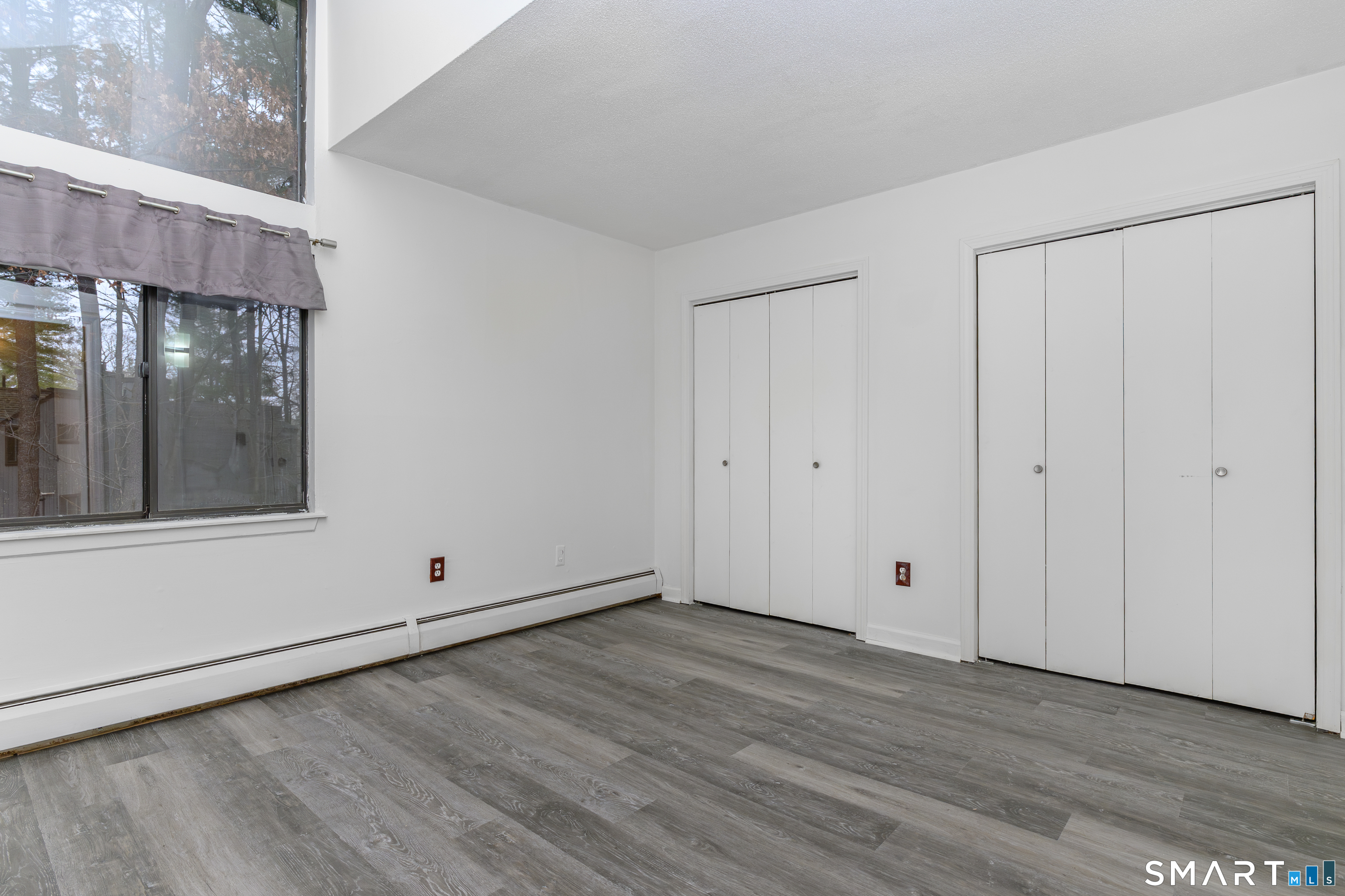 5 Talcott Forest Road, Unit A Farmington, CT 06032 - Photo 17 of 36 a view of an empty room with wooden floor and a window