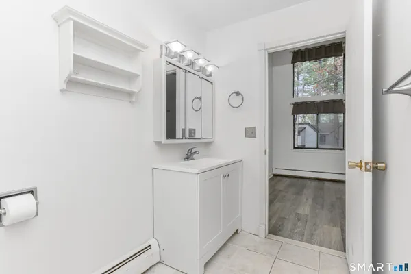 a bathroom with a sink a mirror and a window