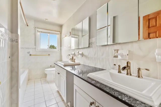 a bathroom with a sink toilet and mirror