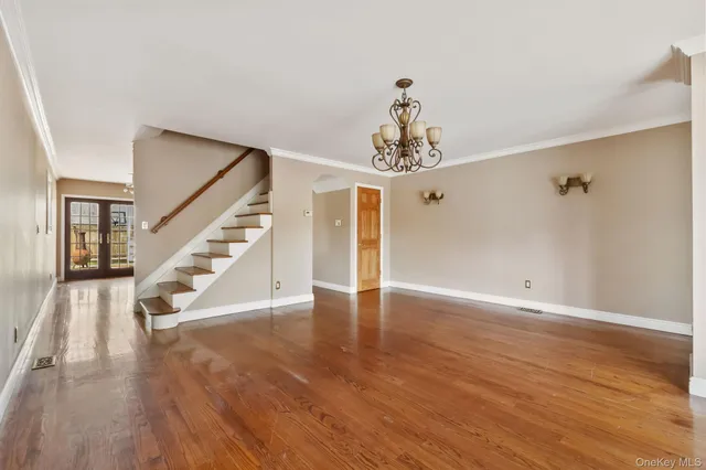 a view of a room with wooden floor and staircase