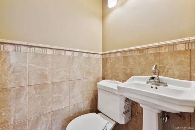 a bathroom with a sink mirror and toilet