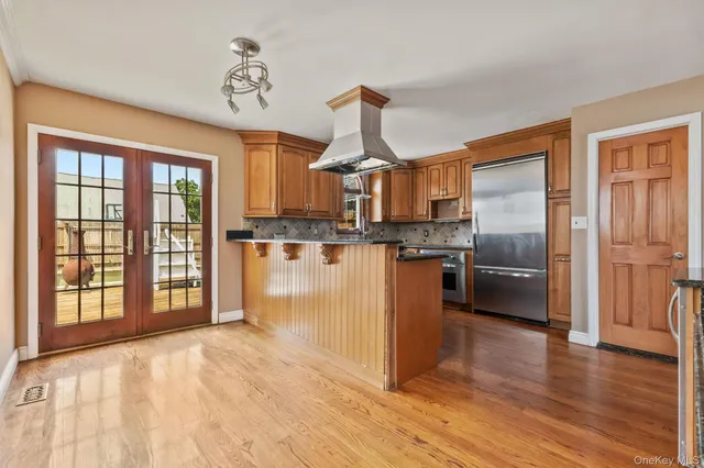 a kitchen with stainless steel appliances granite countertop a refrigerator and a stove top oven