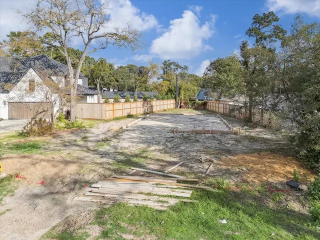 a view of yard with swimming pool and green space