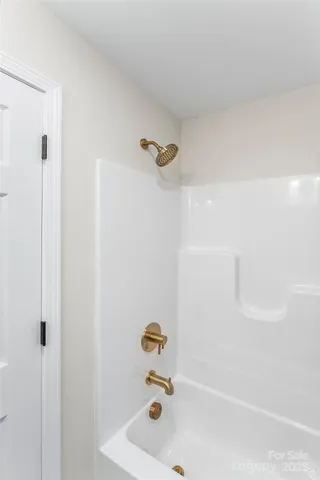 an empty room with a window and a ceiling fan