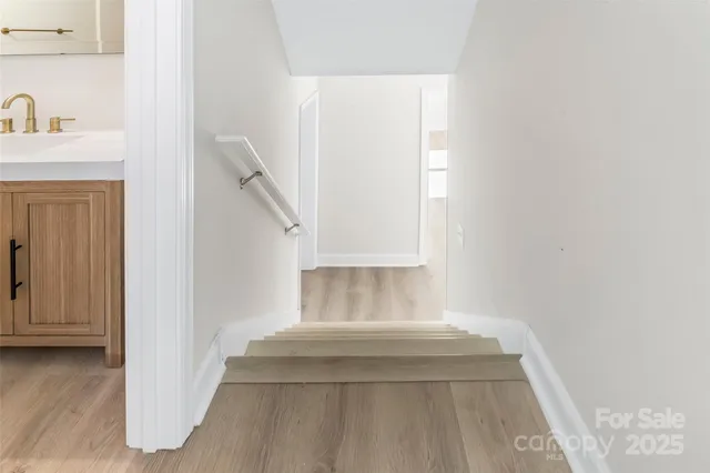 a view of an empty room with window and fireplace