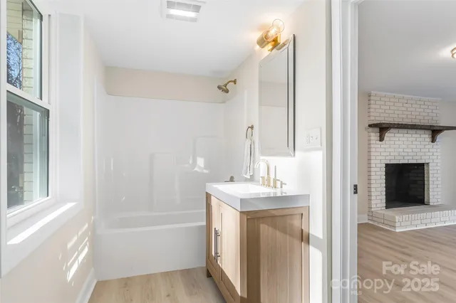 a bathroom with a bathtub sink vanity and a mirror