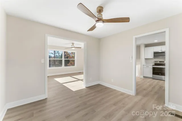 a kitchen with cabinets stainless steel appliances and a sink