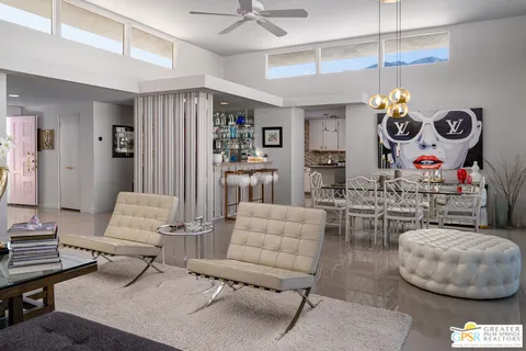 a kitchen with stainless steel appliances granite countertop a sink a stove a dining table and chairs