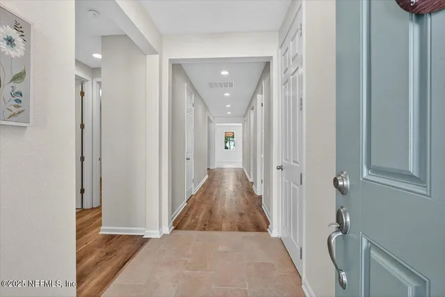 a view of a kitchen with a sink and refrigerator