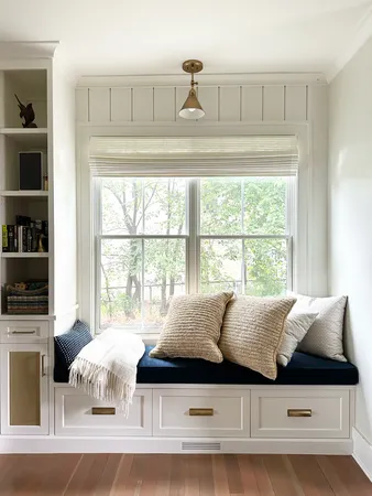 a bedroom with a bed couch and wooden floor