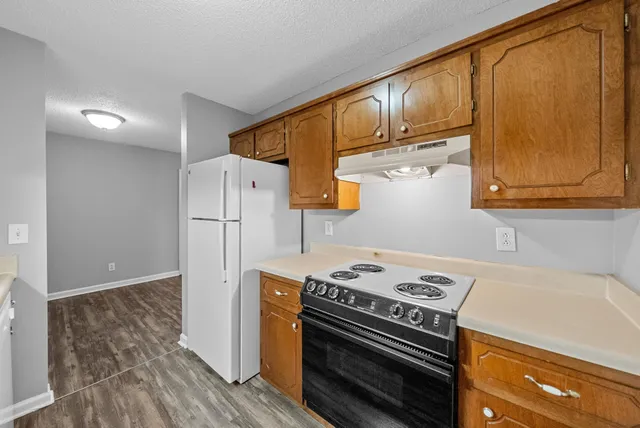 a kitchen with a stove and a refrigerator
