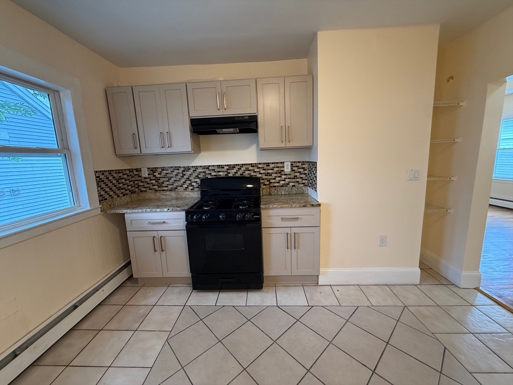 11 Dalrymple Street, Unit 3 Boston, MA 02130 - Photo 10 of 13 a kitchen with a sink and a stove top oven