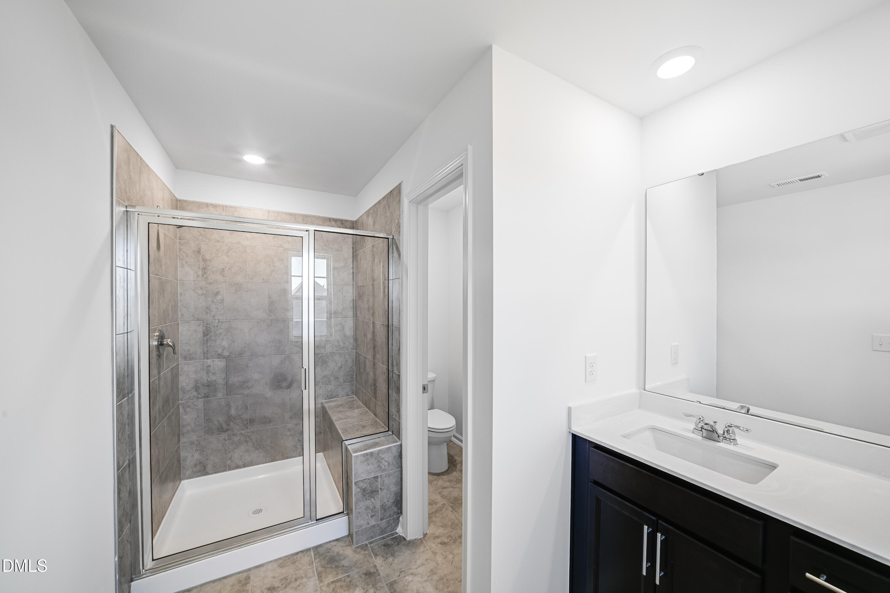 1441 Jay Road Knightdale, NC 27545 - Photo 19 of 57 a bathroom with a shower sink and mirror