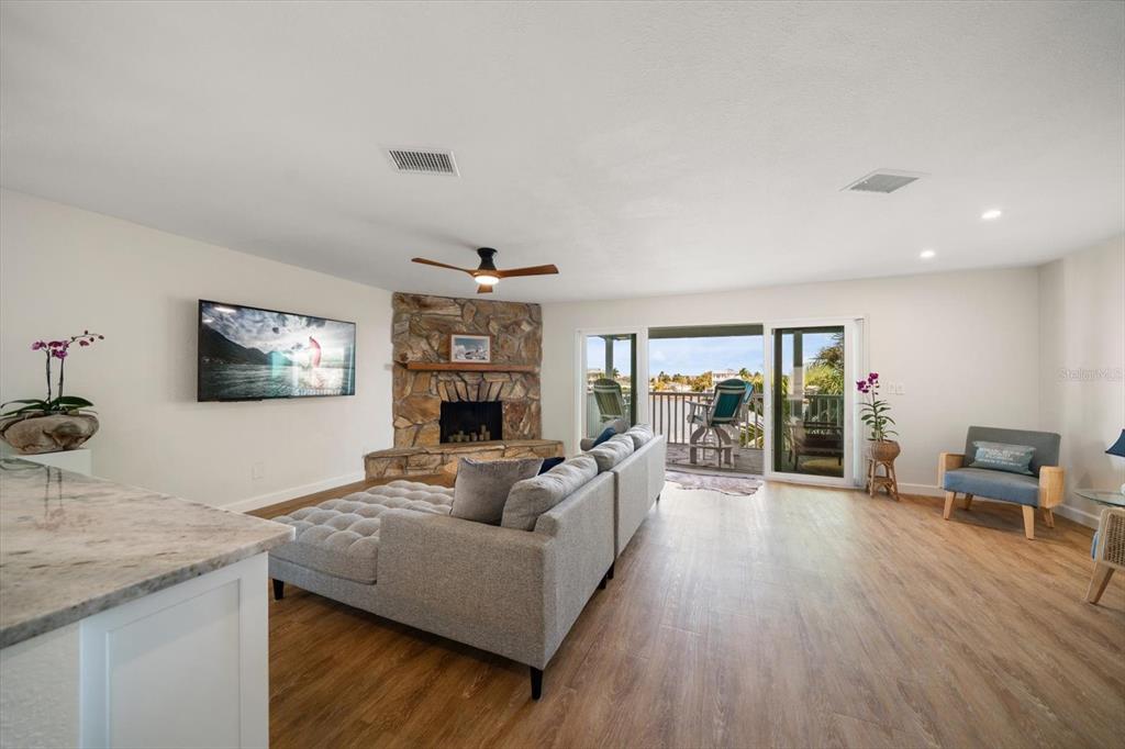 2505 Bay Boulevard, Unit 4 Indian Rocks Beach, FL 33785 - Photo 11 of 63 a living room with furniture and a flat screen tv