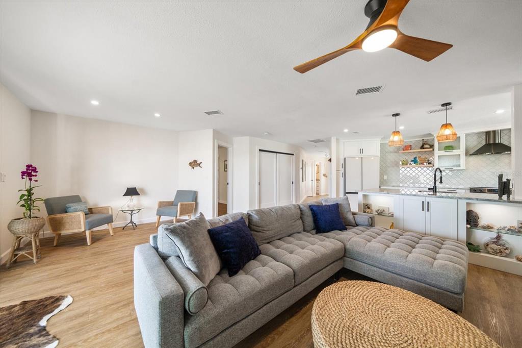 2505 Bay Boulevard, Unit 4 Indian Rocks Beach, FL 33785 - Photo 13 of 63 a living room with furniture and a chandelier