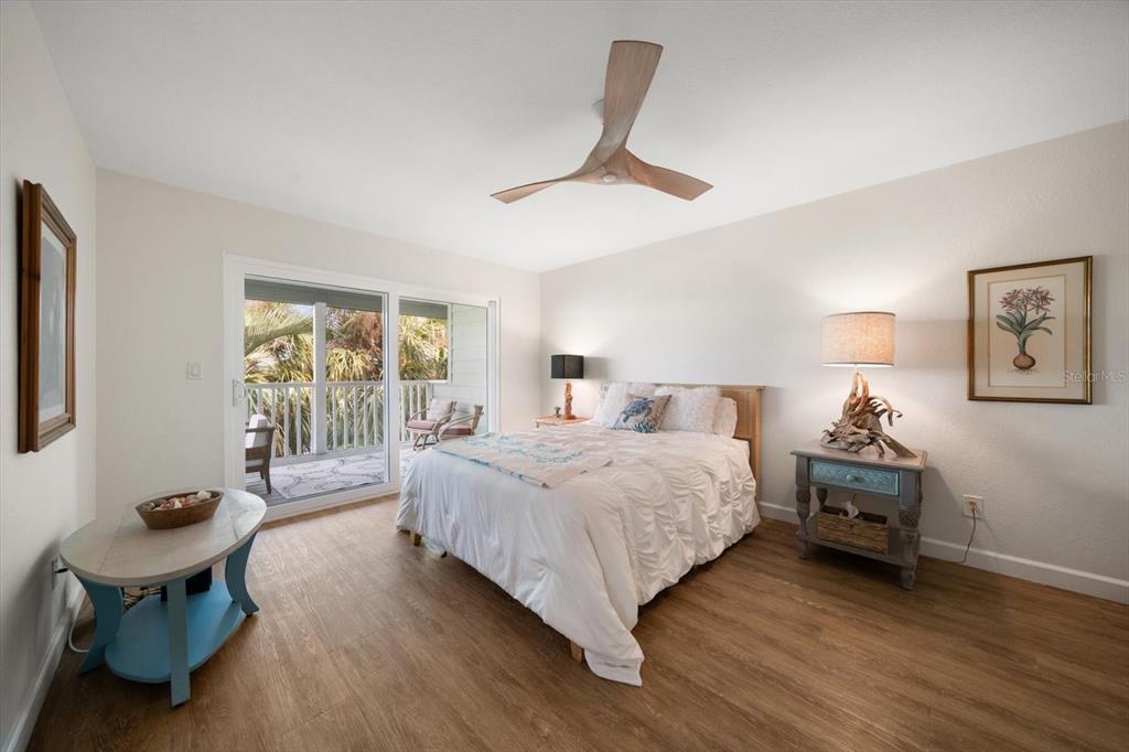 2505 Bay Boulevard, Unit 4 Indian Rocks Beach, FL 33785 - Photo 14 of 63 a bedroom with a bed and glass window