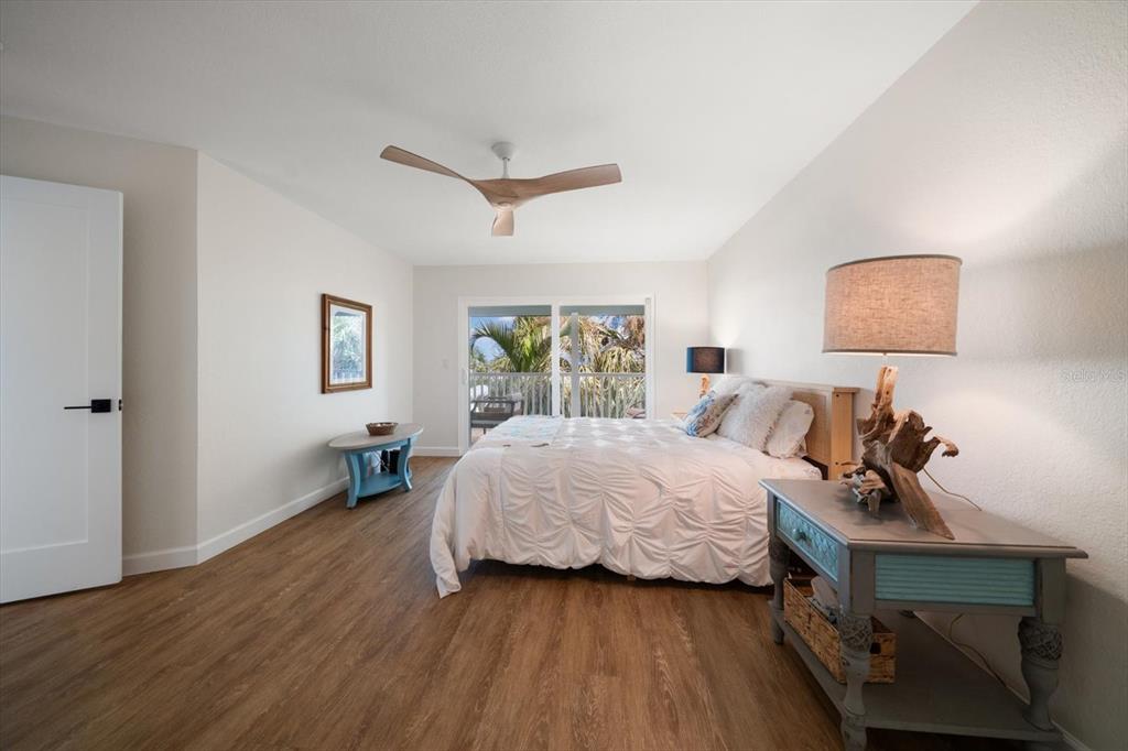 2505 Bay Boulevard, Unit 4 Indian Rocks Beach, FL 33785 - Photo 15 of 63 a bedroom with a bed and wooden floor