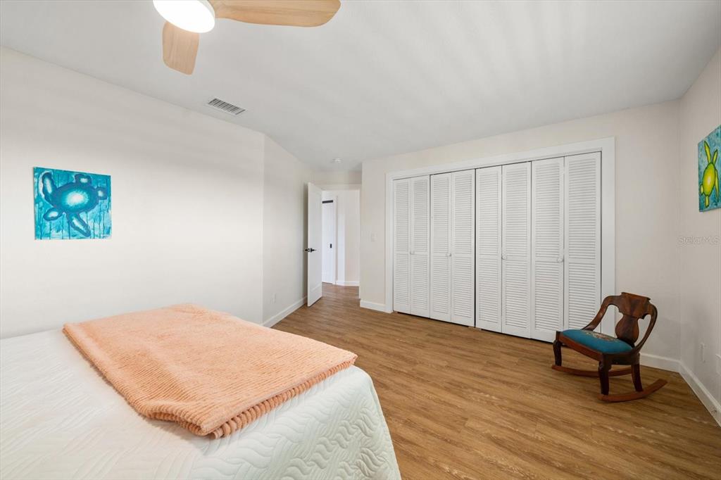 2505 Bay Boulevard, Unit 4 Indian Rocks Beach, FL 33785 - Photo 24 of 63 a bedroom with a bed and a chair