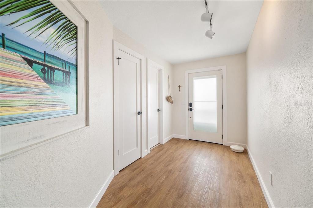2505 Bay Boulevard, Unit 4 Indian Rocks Beach, FL 33785 - Photo 3 of 63 a view of hallway with a large window and wooden floor