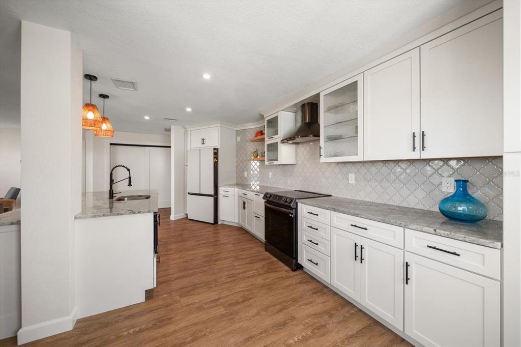 2505 Bay Boulevard, Unit 4 Indian Rocks Beach, FL 33785 - Photo 5 of 63 a kitchen with stainless steel appliances granite countertop a sink and cabinets